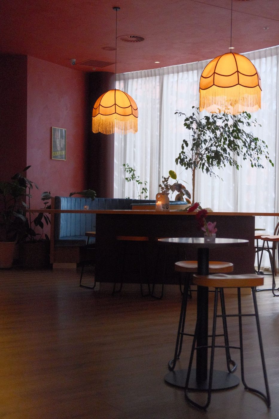 Fringed lamps and velvet booths in the Negroni lounge, curtains drawn over the city