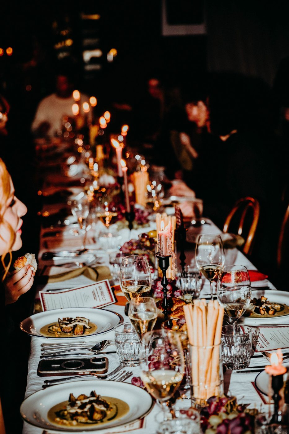 A long candlelit table set for a private event at Bar Franco