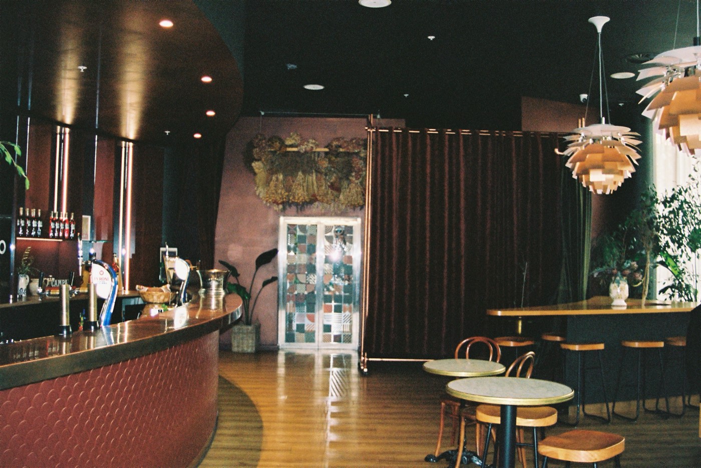 The Level 1 Negroni Bar at Bar Franco — the curved bar, sculptural pendant lights and lounge seating