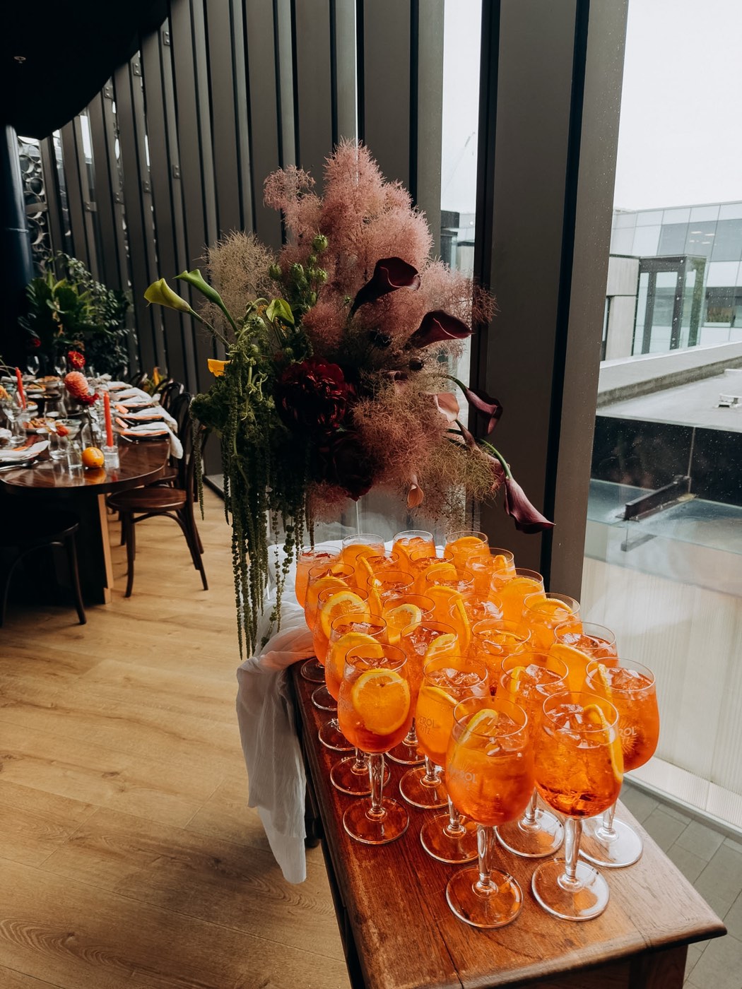 Aperol spritzes lined up by the restaurant windows for guests at Bar Franco
