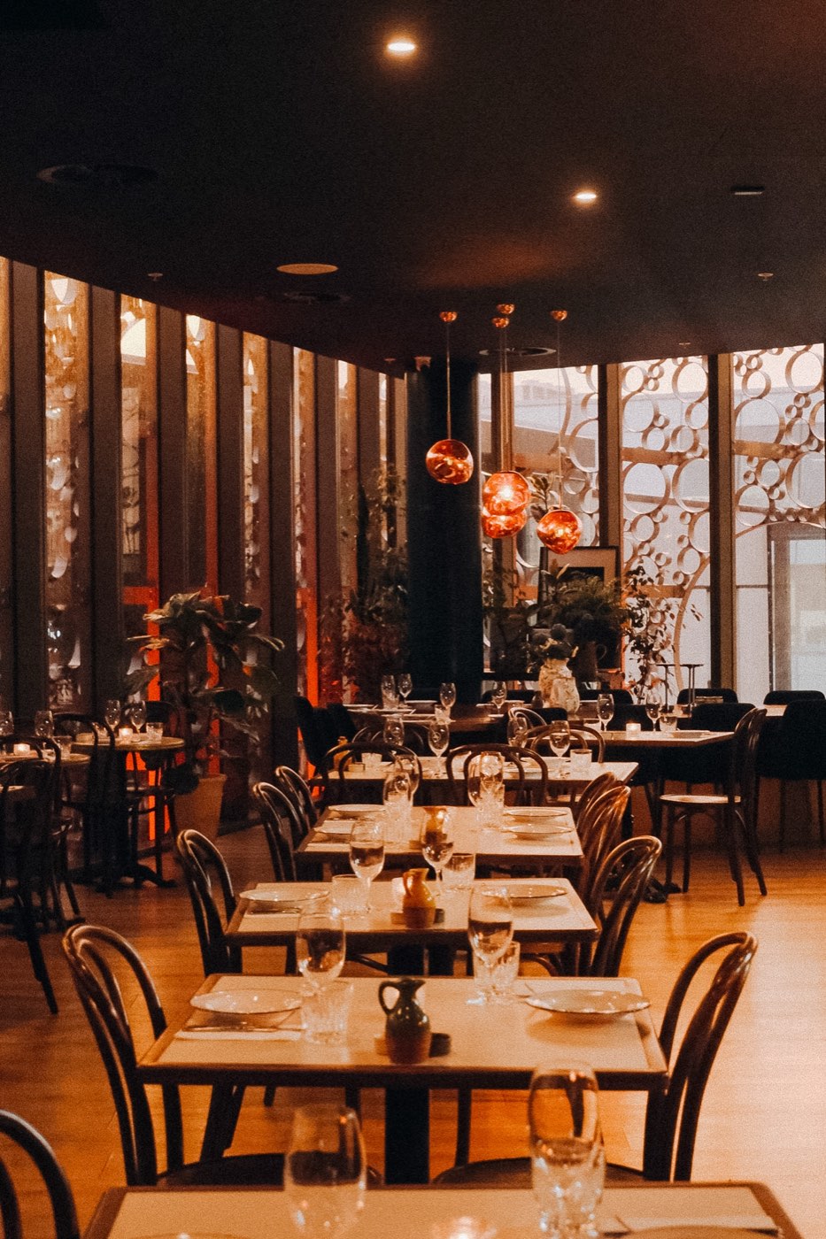 The Level 2 restaurant at Bar Franco set for dinner under copper pendant lights