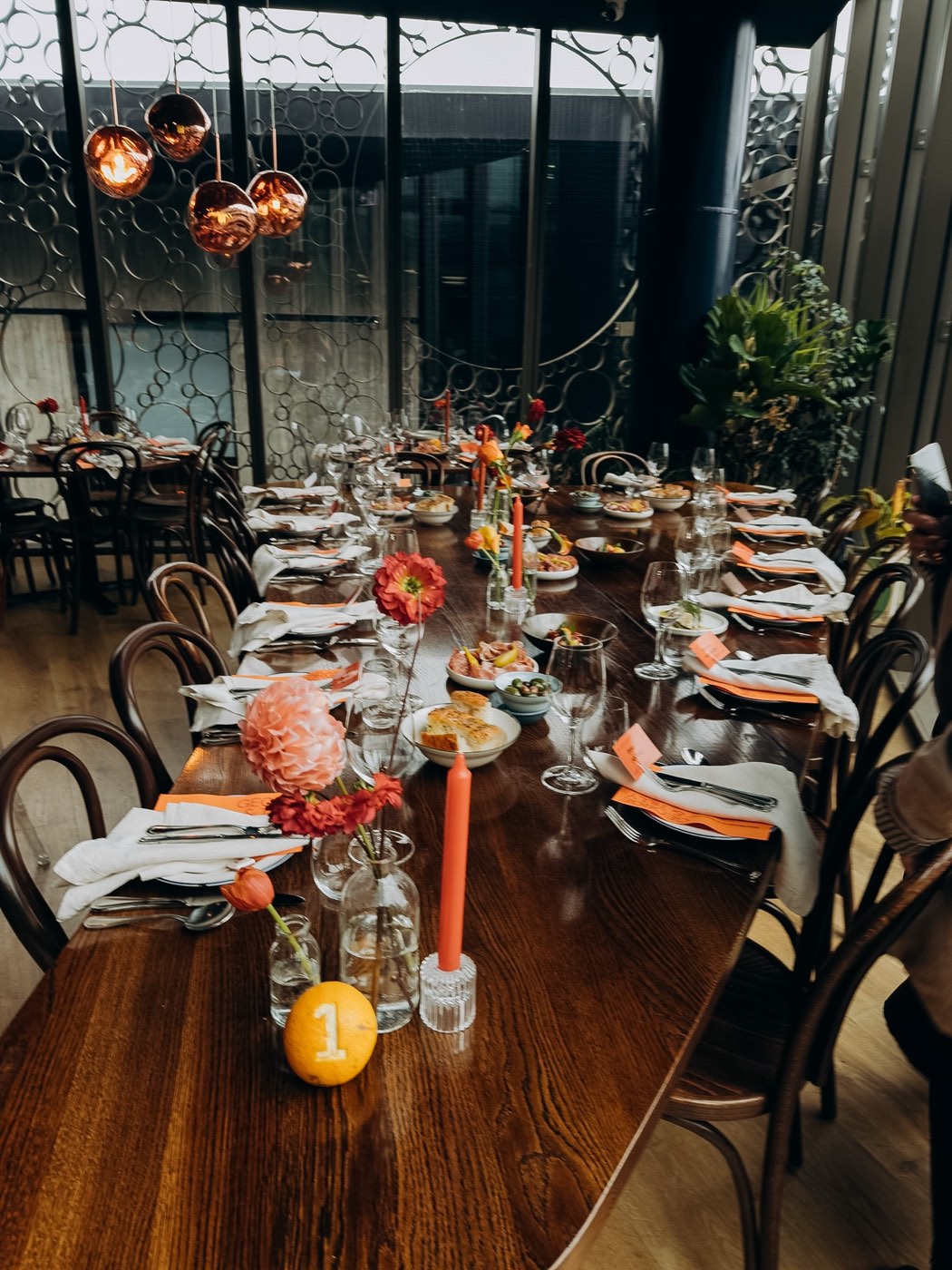 A long table dressed with flowers and candles for a private event at Bar Franco