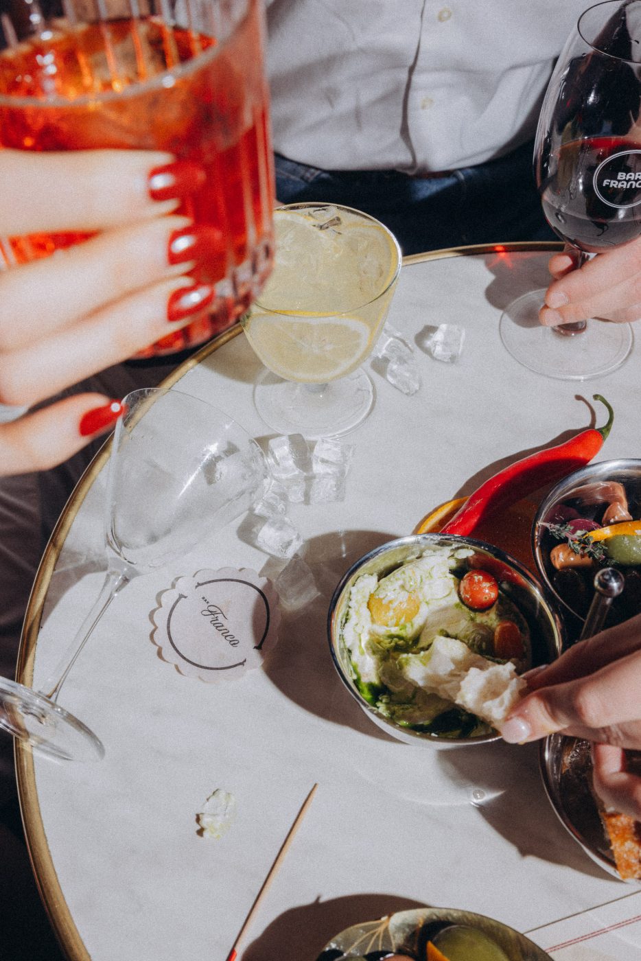 Burrata, olives and antipasti on a marble table at Bar Franco