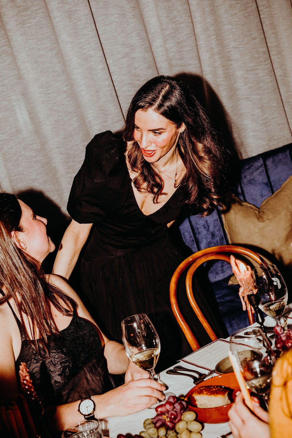 Guests talking across a table in the booth