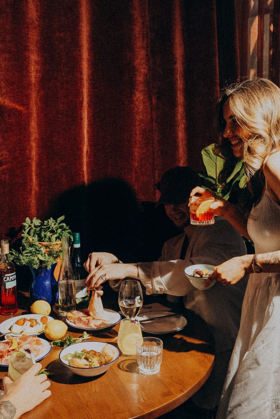 Friends laughing over Negronis, spritzes and antipasti at Bar Franco, Christchurch